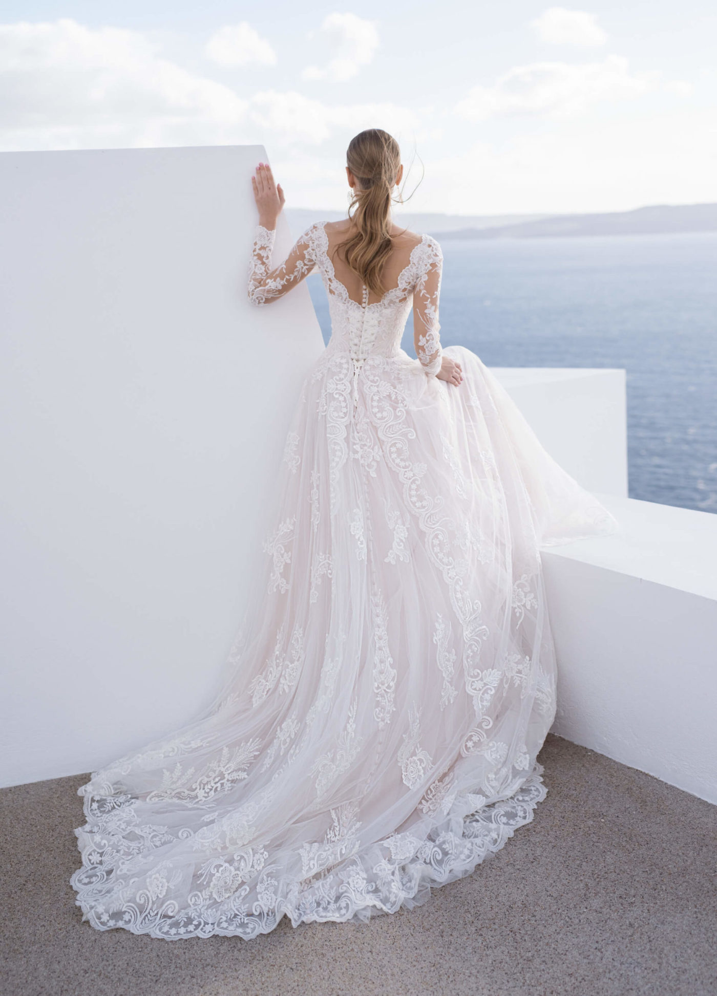 Bridal with Love Blunny Bridal Gorgeous French lace motifs cascade over tulle in this chic sleeved wedding gown